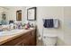 Bathroom featuring a toilet, vanity with a sink, and a mirror with a towel rack at 2900 Shadow Creek Dr # 201, Boulder, CO 80303