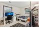 Bedroom with white walls and trim, two windows and a bed with black and white striped rug at 2900 Shadow Creek Dr # 201, Boulder, CO 80303