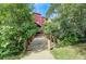 Charming home exterior with a wooden bridge, surrounded by lush greenery at 2900 Shadow Creek Dr # 201, Boulder, CO 80303
