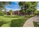 Exterior of home with grassy lawn and paved walkway with well-maintained landscape at 2900 Shadow Creek Dr # 201, Boulder, CO 80303