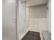 Sleek, modern shower area with frosted glass doors and gray tiled walls at 2900 Shadow Creek Dr # 201, Boulder, CO 80303