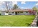Expansive backyard featuring a lush green lawn and mature trees at 3775 S Forest Way, Denver, CO 80237