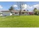 View of the backyard from the far corner of the property with mature landscaping at 3775 S Forest Way, Denver, CO 80237