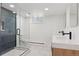 Bright bathroom with a glass shower enclosure, toilet, and a floating vanity with double sinks at 3775 S Forest Way, Denver, CO 80237
