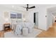 Comfortable bedroom with wood floors, ceiling fan, bedside table, and an ensuite bathroom at 3775 S Forest Way, Denver, CO 80237
