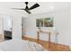 Bright bedroom featuring a modern ceiling fan, wood floors, and view of outside at 3775 S Forest Way, Denver, CO 80237