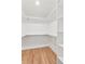 Walk-in closet featuring custom shelving and hardwood floors at 3775 S Forest Way, Denver, CO 80237