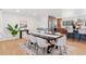 Elegant dining area featuring hardwood floors adjacent to an open kitchen at 3775 S Forest Way, Denver, CO 80237