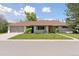 Charming single-story home featuring an attached two car garage and a beautifully maintained front lawn at 3775 S Forest Way, Denver, CO 80237