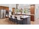 Modern kitchen with stainless appliances, breakfast bar, and hardwood floors at 3775 S Forest Way, Denver, CO 80237