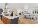 Bright open kitchen with center island and an adjacent dining area with access to the living room at 3775 S Forest Way, Denver, CO 80237
