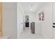 A bright laundry room with modern appliances, counter space, natural light, and an attached half bathroom at 3775 S Forest Way, Denver, CO 80237