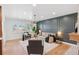 Living room showcasing wainscotting detail, modern furnishings, and natural light from the shuttered windows at 3775 S Forest Way, Denver, CO 80237