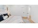 Cozy primary bedroom with neutral color palette, hardwood floors, and access to the ensuite bathroom at 3775 S Forest Way, Denver, CO 80237