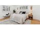 Bright bedroom with hardwood floors, white shudders, neutral decor, and comfortable bedding at 3775 S Forest Way, Denver, CO 80237