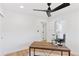 Home office featuring hardwood floors, modern desk, and access to the ensuite bathroom at 3775 S Forest Way, Denver, CO 80237