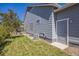 Backyard features a well-maintained lawn, mature trees, and an access door at 12574 Lake View St, Longmont, CO 80504