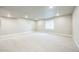 Bright basement features recessed lighting, neutral carpet, and a large window at 12574 Lake View St, Longmont, CO 80504