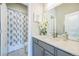 Bathroom featuring a single sink vanity with a white countertop and a shower/tub with a floral curtain at 12574 Lake View St, Longmont, CO 80504