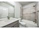 Well-lit bathroom featuring a shower-tub combo with tiled walls and a single sink vanity at 12574 Lake View St, Longmont, CO 80504