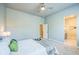 Bright bedroom with a ceiling fan, plush carpet, access to a walk-in closet, and an ensuite bathroom at 12574 Lake View St, Longmont, CO 80504