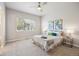 Bright bedroom with a ceiling fan, big window, and neutral decor that creates a serene and inviting atmosphere at 12574 Lake View St, Longmont, CO 80504