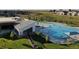 Aerial view of the community pool and clubhouse, surrounded by well-maintained landscaping at 12574 Lake View St, Longmont, CO 80504