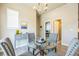 Inviting dining room with a glass-top table, modern chandelier, and neutral decor for a cozy ambiance at 12574 Lake View St, Longmont, CO 80504
