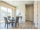 Cozy dining area with sliding glass doors leading to a patio and adjacent to the kitchen and hallway at 12574 Lake View St, Longmont, CO 80504