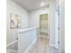 Well-lit hallway featuring modern flooring and leading to other areas of the home at 12574 Lake View St, Longmont, CO 80504