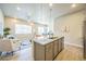 Bright kitchen with center island, pendant lighting, stainless appliances, and easy access to the living area at 12574 Lake View St, Longmont, CO 80504