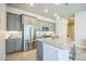 Modern kitchen boasts granite countertops, stainless steel appliances, gray cabinets, and a large island at 12574 Lake View St, Longmont, CO 80504