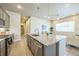 Well-equipped kitchen featuring granite countertops, stainless steel appliances, and access to hall and living room at 12574 Lake View St, Longmont, CO 80504