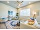 Stylish living room with comfortable seating, large windows, and a beautifully patterned area rug at 12574 Lake View St, Longmont, CO 80504