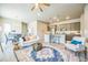 Open-concept living room featuring hardwood floors, stylish decor, and seamless flow into kitchen and dining area at 12574 Lake View St, Longmont, CO 80504