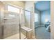 Modern walk-in shower with a built-in bench, tiled walls, and glass door, seamlessly connected to the bedroom at 12574 Lake View St, Longmont, CO 80504