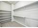 A spacious walk-in closet with built-in shelves and hanging rods, providing ample storage space at 12574 Lake View St, Longmont, CO 80504