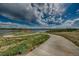 Inviting walking path winds through lush green spaces in this beautiful community at 12574 Lake View St, Longmont, CO 80504