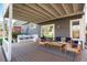 Inviting back porch with string lights and comfortable seating overlooking the spacious, green backyard at 9742 Burntwood Ct, Highlands Ranch, CO 80126