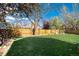 Spacious and well-maintained back yard featuring a lush lawn and privacy fence at 9742 Burntwood Ct, Highlands Ranch, CO 80126