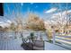 Outdoor balcony with white railings, bistro table, and chairs, perfect for enjoying the view at 9742 Burntwood Ct, Highlands Ranch, CO 80126