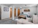 Basement bedroom featuring a queen bed, sitting area, neutral tones and closet space at 9742 Burntwood Ct, Highlands Ranch, CO 80126