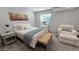 Cozy bedroom with a chair, a bench, and a white dresser at 9742 Burntwood Ct, Highlands Ranch, CO 80126