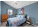 Comfortable bedroom with a blue accent wall and patterned curtains at 9742 Burntwood Ct, Highlands Ranch, CO 80126