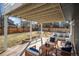 Relaxing covered deck features comfortable seating, string lights, and views of the backyard at 9742 Burntwood Ct, Highlands Ranch, CO 80126