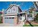 Charming two-story home with a well-manicured lawn, gray siding, and a welcoming front porch at 9742 Burntwood Ct, Highlands Ranch, CO 80126