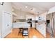 Contemporary kitchen featuring white cabinets, stainless steel appliances, and island with seating at 9742 Burntwood Ct, Highlands Ranch, CO 80126