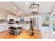 Bright, updated kitchen with white cabinets, stainless steel appliances, and a center island with seating at 9742 Burntwood Ct, Highlands Ranch, CO 80126