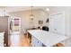 Well-lit kitchen adjacent to dining and living areas, featuring white cabinets and a kitchen island at 9742 Burntwood Ct, Highlands Ranch, CO 80126