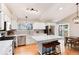 Modern kitchen featuring white cabinetry, stainless steel appliances, and center island with seating at 9742 Burntwood Ct, Highlands Ranch, CO 80126